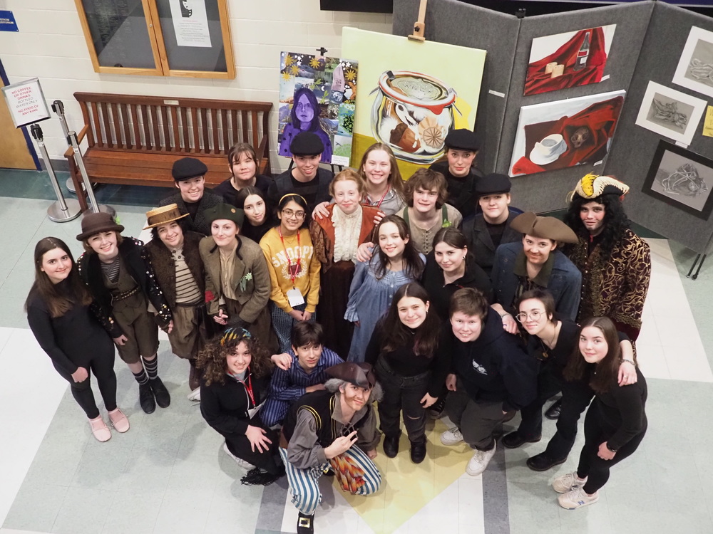 high school drama students pose after theatre performance