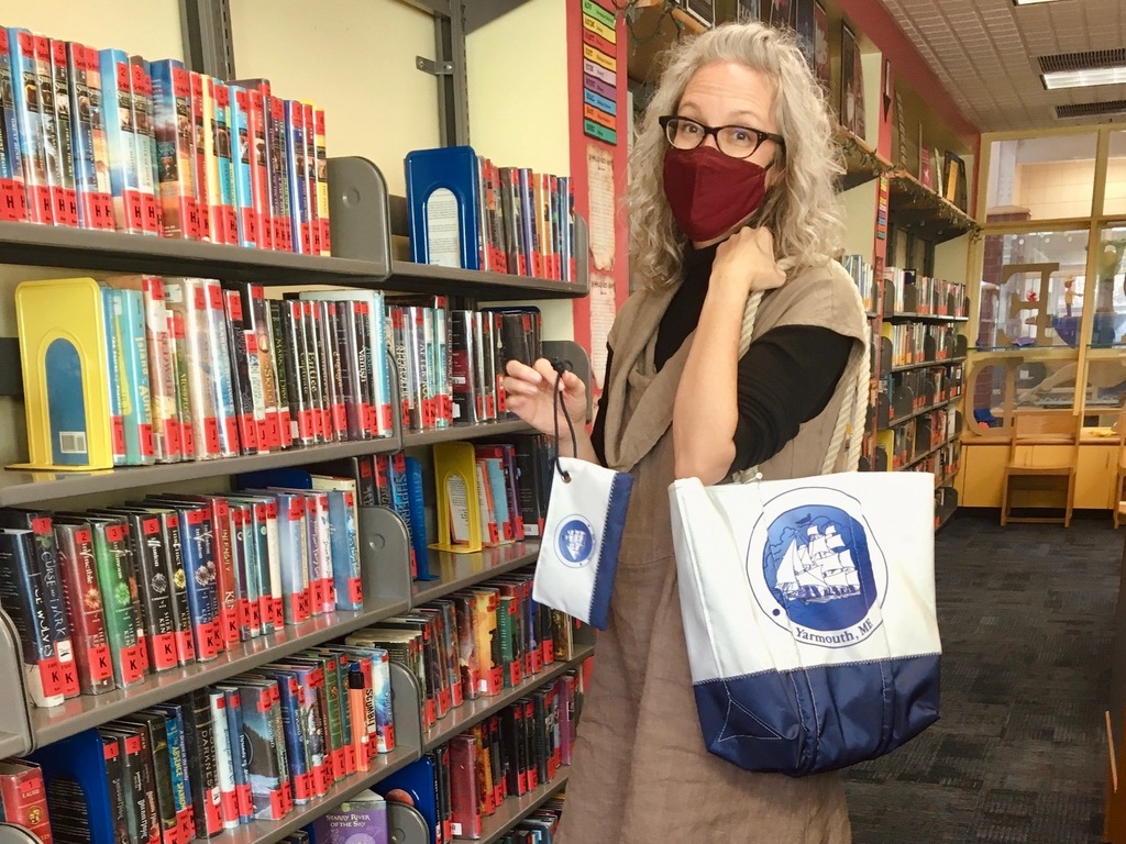 HMS Librarian Brandie Burrows with our fundraiser Sea Bag tote and wristlet items