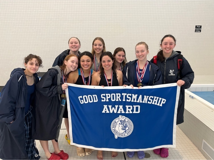girls swim team with banner 