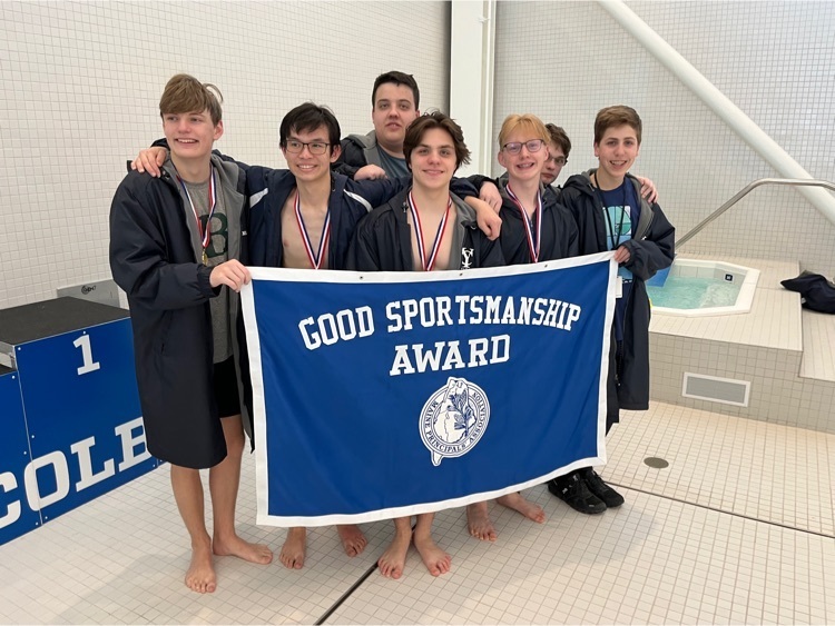boys swim team with banner