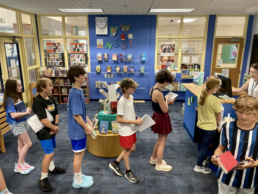 Students in line to check out books in the HMS Library