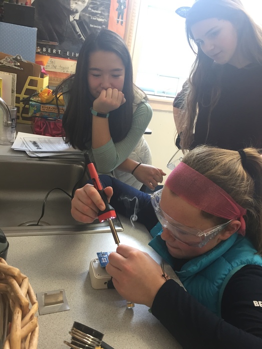 7th graders soldering switches for Sea Perch