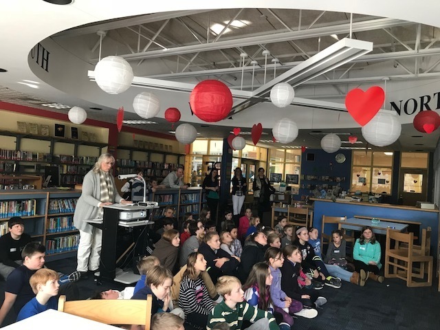 2nd and 6th grade students enjoy a story in the HMS library